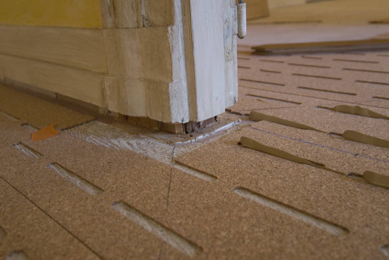 The parquet floor will go under the baseboards